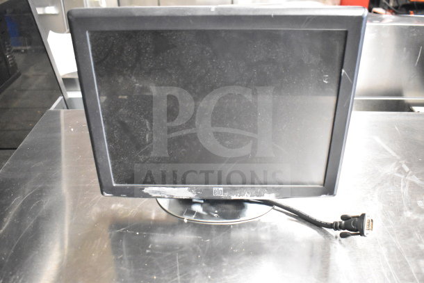 Toshiba monitor with visible external wear, connected power cord, part of 15-item lot with printers and phone.