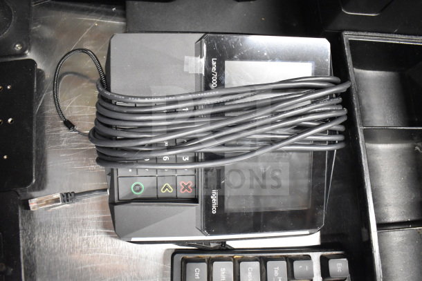Ingenico Lane 7000 credit card reader with coiled cable, near keyboard. Used condition. Part of 15-item auction lot.