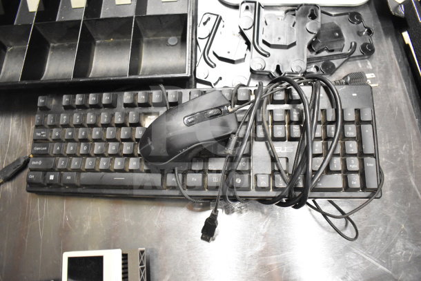 Black ASUS keyboard with wired mouse, cash drawer insert, mounting brackets, and card reader on a metal surface.
