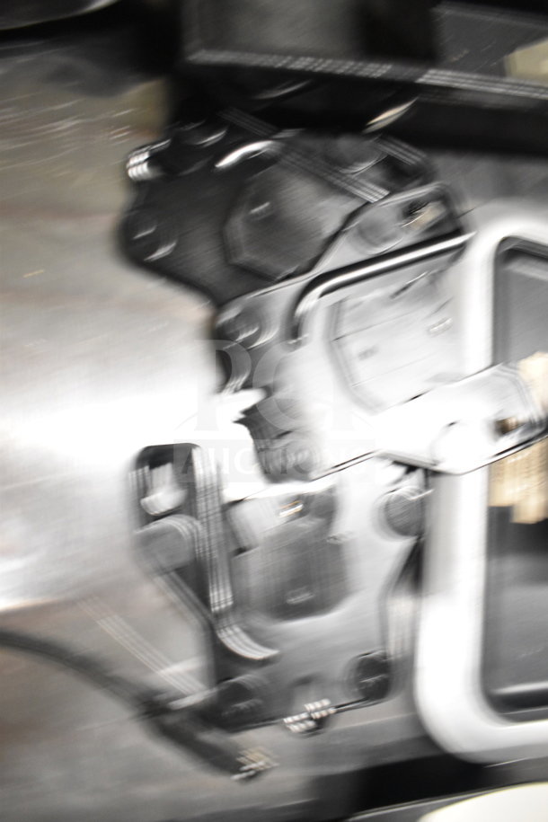 Blurry image showing indistinct black and silver objects, part of a lot including various business hardware.