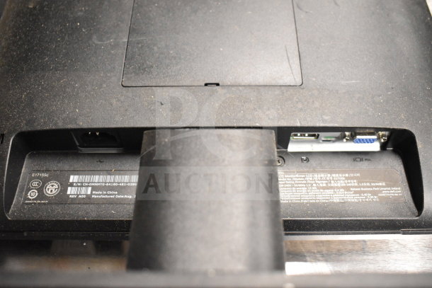 Close-up of a Dell monitor's back panel showing power and input ports, serial number E1715Sc, made in China, good condition.