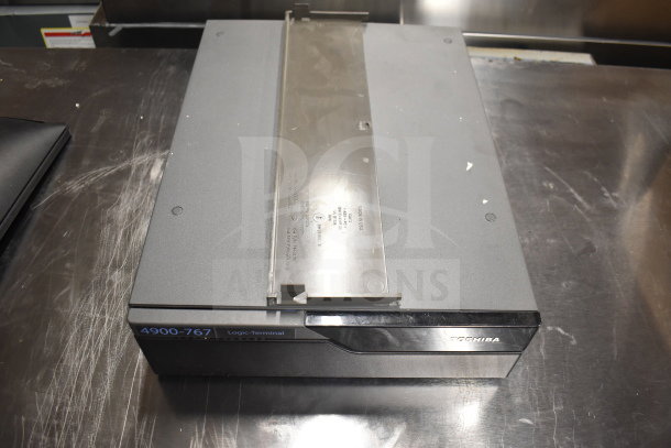 Toshiba 4900-767 Logic Terminal on metal surface, labeled with model number. Part of auction lot of 15 items.
