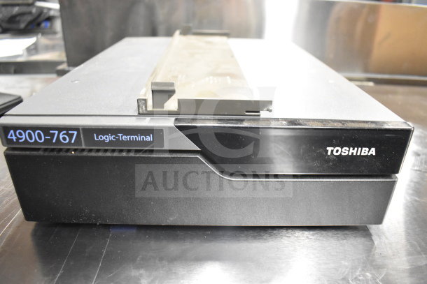 Toshiba 4900-767 Logic-Terminal shown, black with visible labeling, part of a 15-item auction lot.