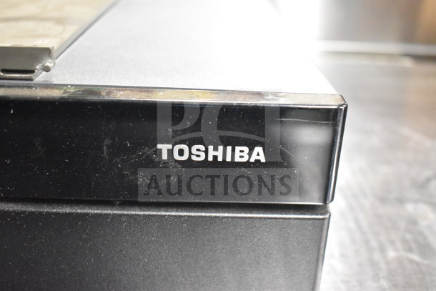 Toshiba electronic device, likely part of a lot including receipt printer, keyboard, card reader, and cash drawer insert.