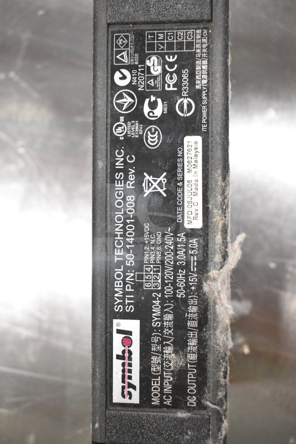 Close-up of a Symbol Technologies Inc. label on a device, model SYM042, detailing electrical specifications and certifications.