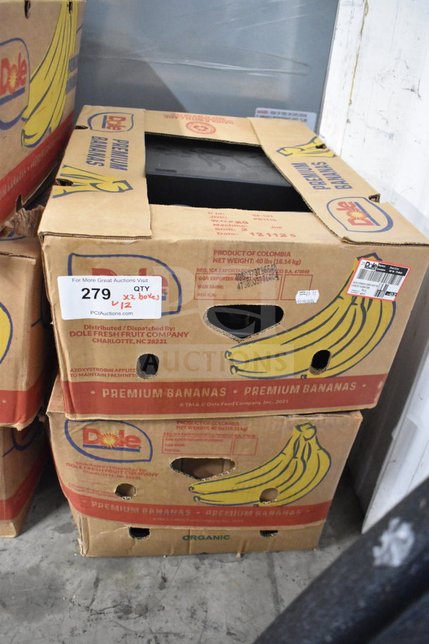 Two stacked banana boxes containing Dell computer towers, part of an auction lot of 12 items, marked as lot 279.
