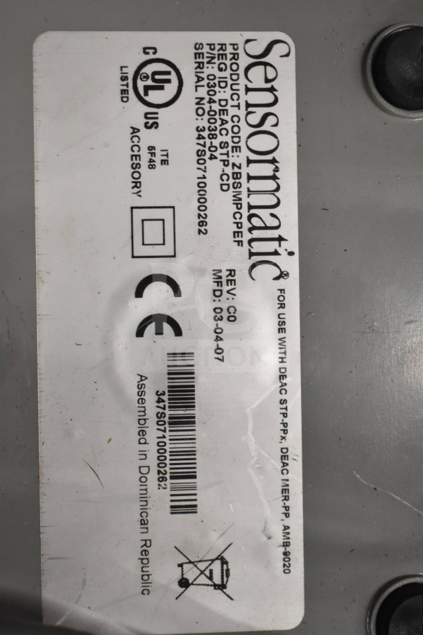 Label on electronic item, Sensormatic, product code ZBSMPCPEF, Rev: C0, MFD: 03-04-07, UL and CE markings.