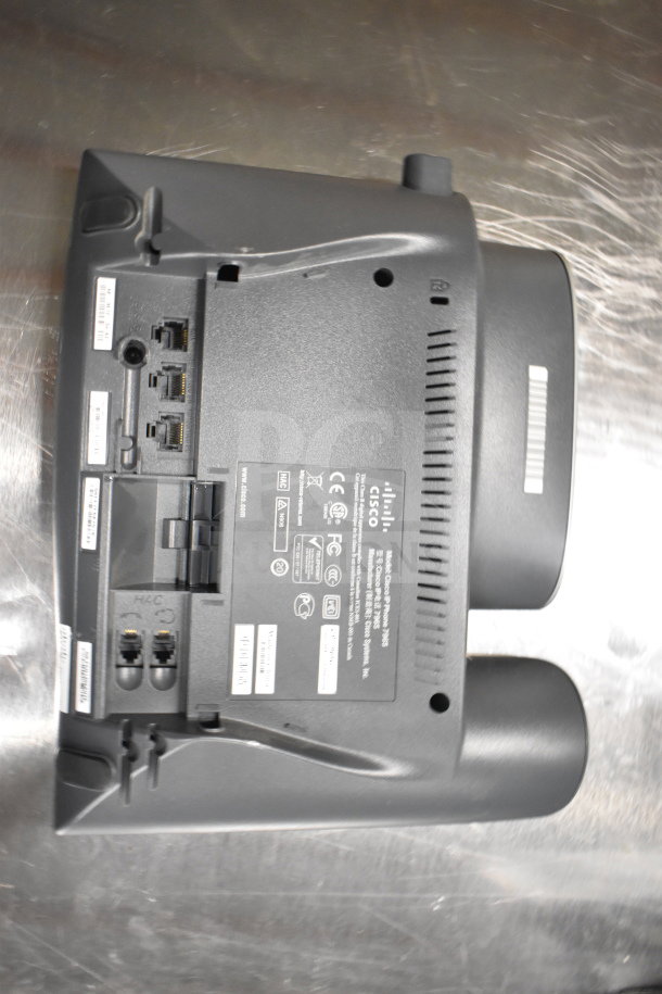 Cisco office phone model CP-7945G, rear view showing ports and labels. Part of a lot including computer towers and card reader.