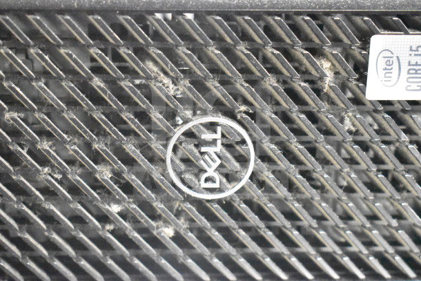 Dell computer tower with Intel Core i5 badge, showing slight dust accumulation. Auction includes 12 items.
