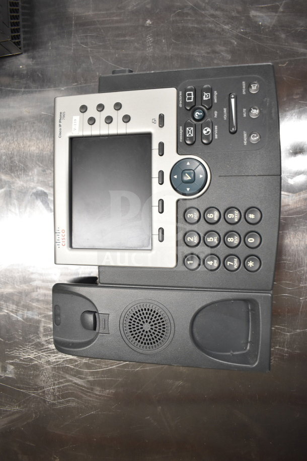 Cisco office telephone with screen, numeric keypad, and function buttons. Includes speaker and headset port. In good condition.