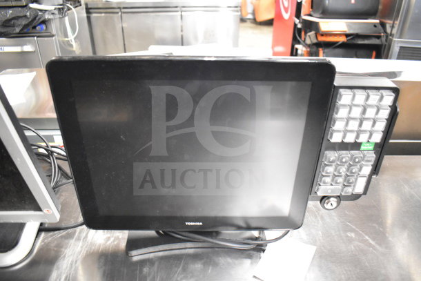 Toshiba touchscreen monitor with attached numeric keypad and cables. Part of an auction lot of 12 items, including computers and phones.