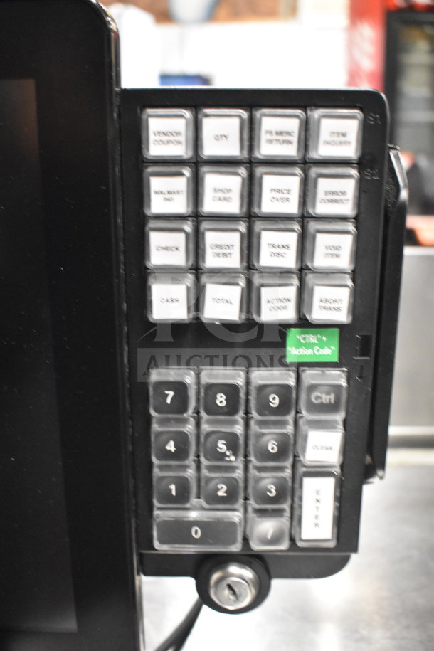 Close-up of a credit card reader keypad with numbered buttons and labeled function keys, including "Credit Debit" and "Cash".