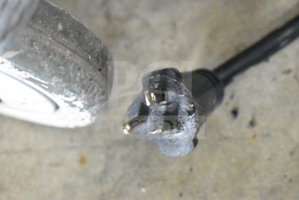 Close-up of a power plug and wheel of a Hatco TQ-800HBA Commercial Conveyor Toaster Oven, 208V, 1 Phase.