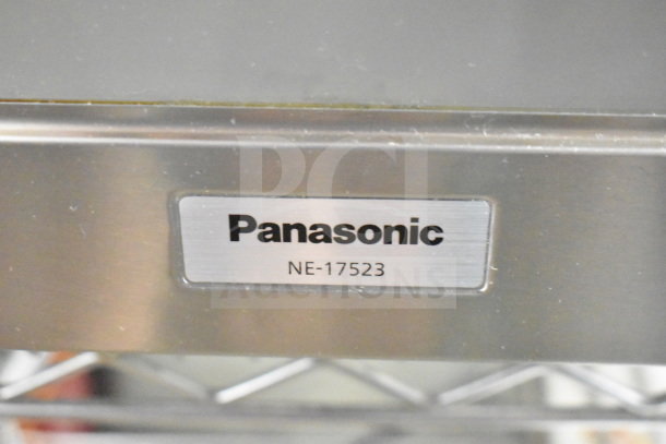 Panasonic NE-17523 commercial countertop microwave oven, stainless steel finish, model and brand label visible.