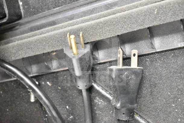 Power cords of Federal Commercial Floor Style Island Grab N Go Merchandiser with visible plug ends, indicating electrical compatibility.