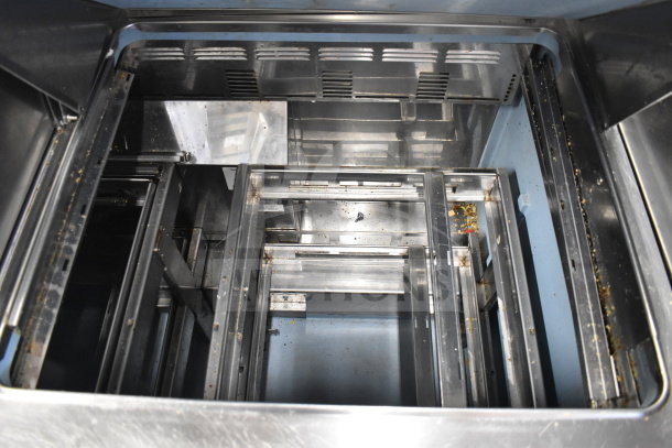 2017 Delfield D4472N-30M sandwich salad prep table interior, showing six drawer frames, minor wear.