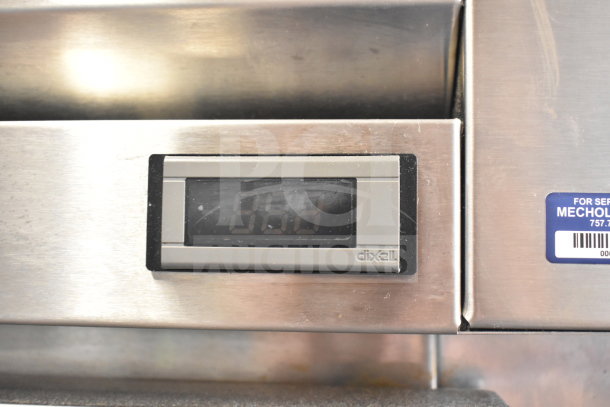 2017 True STA1FRI-1S cooler control panel displaying temperature, with service label on stainless steel surface.