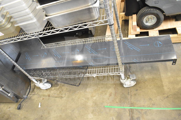Two-tier metal cart with various drop-in bins. Includes metal and plastic containers, caster wheels. Items appear in good condition.