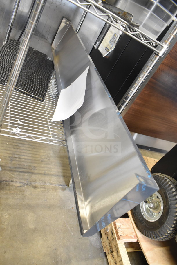 Two-tier metal storage shelf with drop-in bins, stainless steel finish, industrial wheels, and visible tags. Good condition.