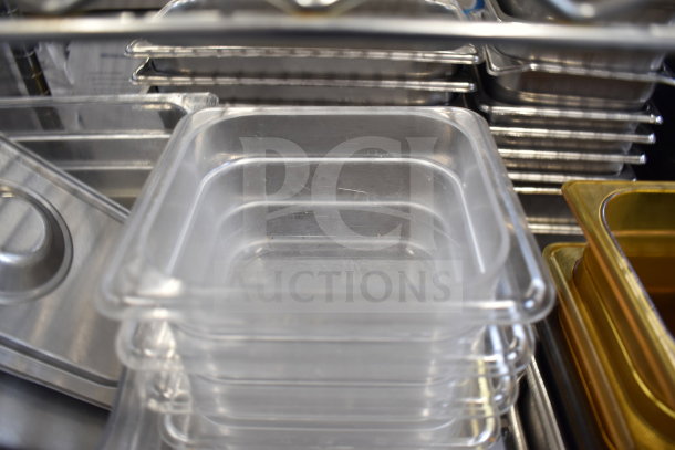 Two-tier lot of various metal and plastic drop-in bins, stacked, in used condition, suitable for storage or organization.