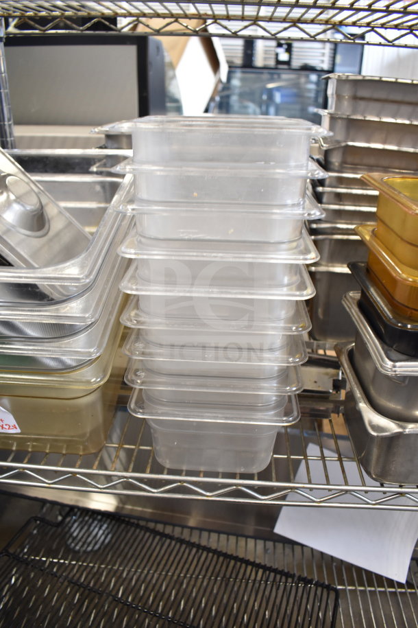 Two-tier metal shelving with assorted clear drop-in bins and metal trays, in used condition.