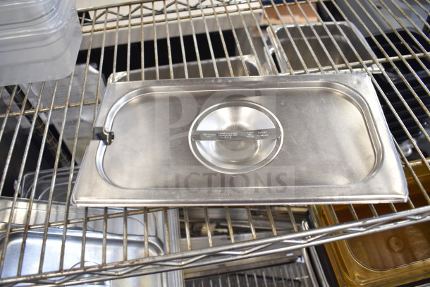 Two-tier lot with stainless steel drop-in bins on metal shelves. Some bins have labels indicating brand and item details.