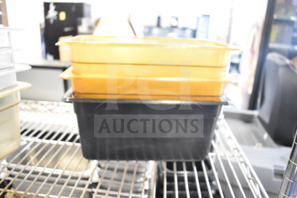 Two-tier lot with drop-in bins, featuring orange and black stacking containers on wire shelving, in good condition.