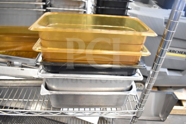 Two-tier lot with various drop-in bins in metal and plastic, stacked on a metal shelf.