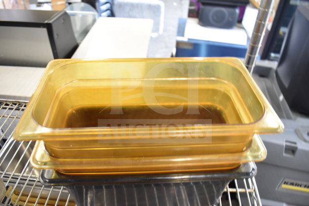 Two-tiered metal rack holding stackable amber drop-in bins, in good condition, for versatile storage solutions.