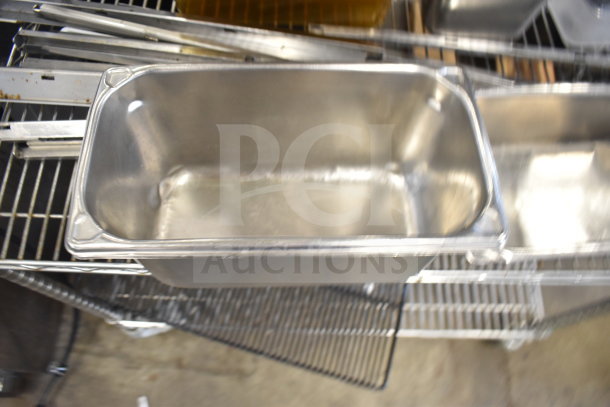 Two-tier lot featuring stainless steel drop-in bins on metal shelving, used condition.