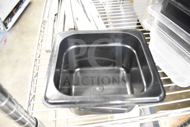 Two-tier lot with various items including a black plastic drop-in bin on a metal rack. Items are in used condition.