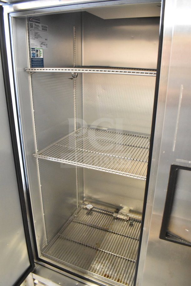 2020 True T-49-HC commercial 2-door reach-in cooler, stainless steel, 115 volts, 1 phase, shelving inside, open door view.