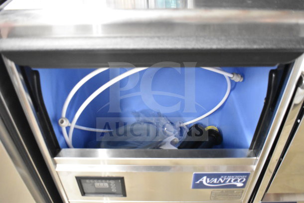 Brand new Avantco 194UN200A commercial undercounter dishwasher with scratches. Includes hose and fittings. Model label visible.