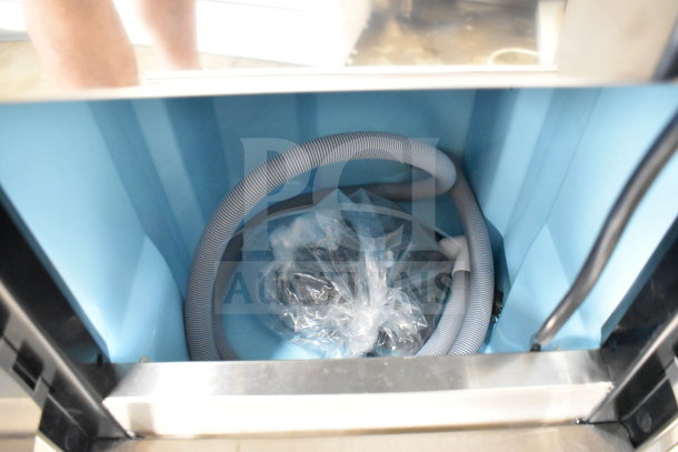 Brand new Avantco 194EUCG80A undercounter ice machine interior, showing hoses and a wrapped component. 115V, 33 lb. bin.