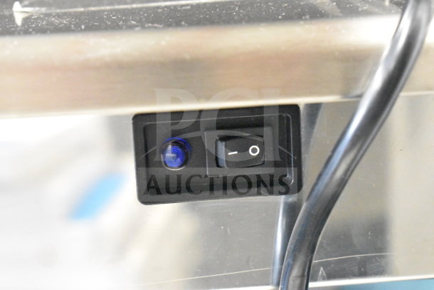 Avantco 194EUCG80A ice machine power switch and indicator light on stainless steel surface.