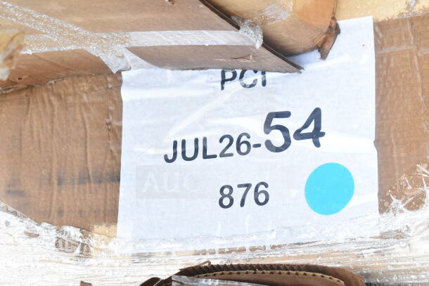 Cardboard packaging labeled "JUL26-54" for auction, containing four new scratch and dent items: work table, cutting board, pan rack.