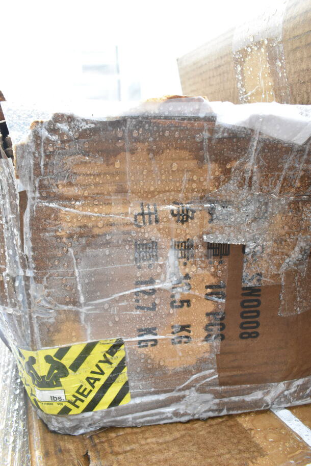 Box with water droplets and tape, marked "HEAVY." Contains brand new scratch and dent items like work table and shelves.