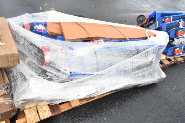 Two brand new Lavex 481XN25DF400 manual pallet jacks with 4,400 lb. capacity, wrapped in plastic on a pallet, showing light scratches and dents.