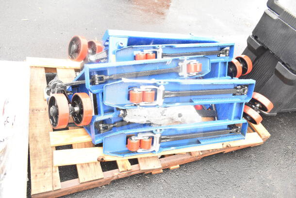 3 brand new Lavex 481XN25DF400 manual pallet jacks, 17" x 35 1/2", 4,400 lb capacity, stacked on a wooden pallet.