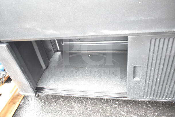 Black portable buffet station, brand new with minor scratches. Open compartment shown. Durable material, sleek design.