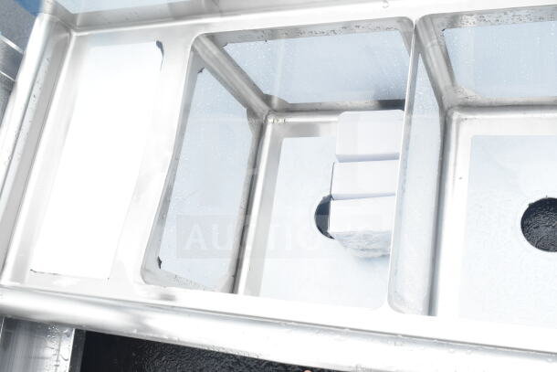 Brand new Steelton 522CS31416LR 66" three compartment sink, two 12" drainboards, 14"x16"x12" bowls, minor dents.