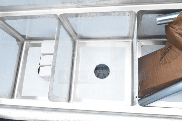 Brand new Steelton 66" three compartment sink with two 12" drainboards, 14"x16"x12" bowls; scratch and dent condition.