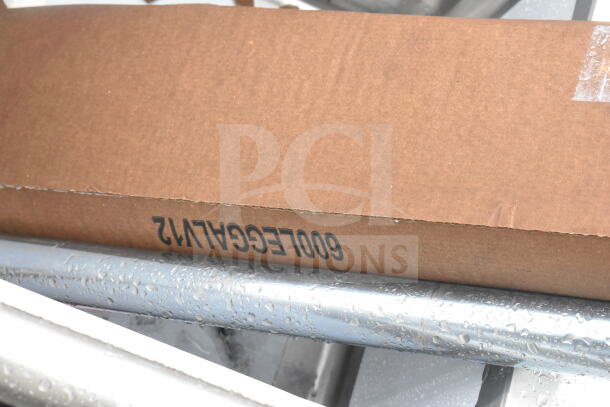 Cardboard box labeled "600LEGCA1V2" atop a metal structure. Packaging suggests contents inside. No visible sink details.