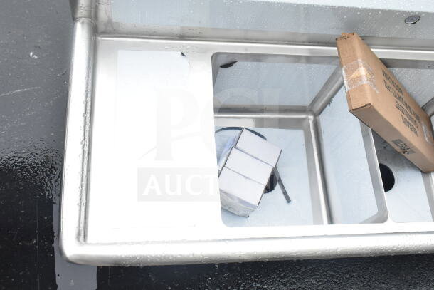 Steelton 522CS31416LR 66" three-compartment sink with two 12" drainboards; new with minor dents.