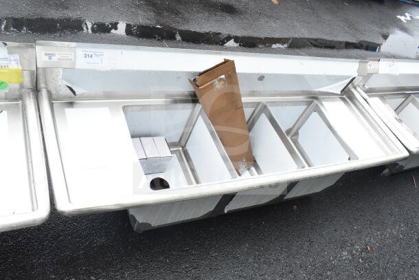 Brand new Steelton 522CS31416LR 66" three-compartment sink, two 12" drainboards, 14" x 16" x 12" bowls, slight scratch and dent.