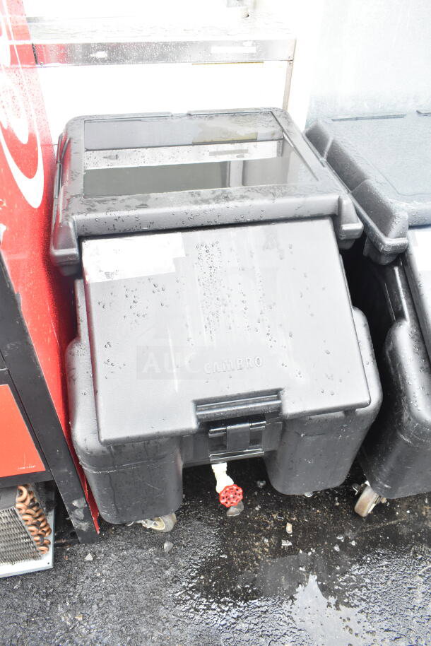Cambro black poly portable ice bin on commercial casters, brand new with scratch and dent, visible handle and drainage spout.