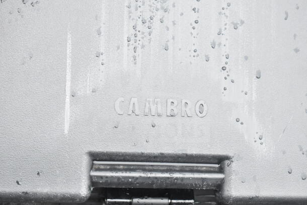 BRAND NEW SCRATCH AND DENT Cambro black poly portable ice bin on commercial casters; visible Cambro logo imprint.