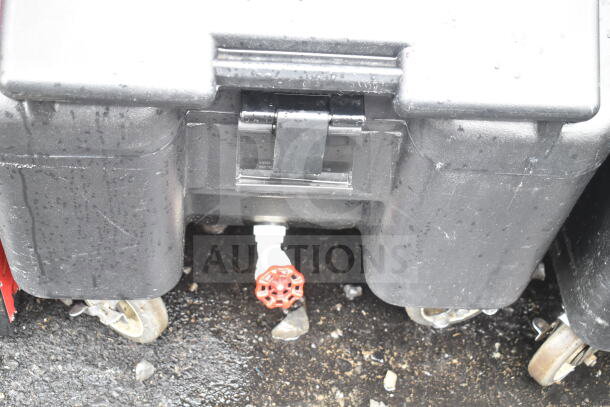 BRAND NEW Cambro black poly portable ice bin on commercial casters, with minor scratches; includes drainage valve.