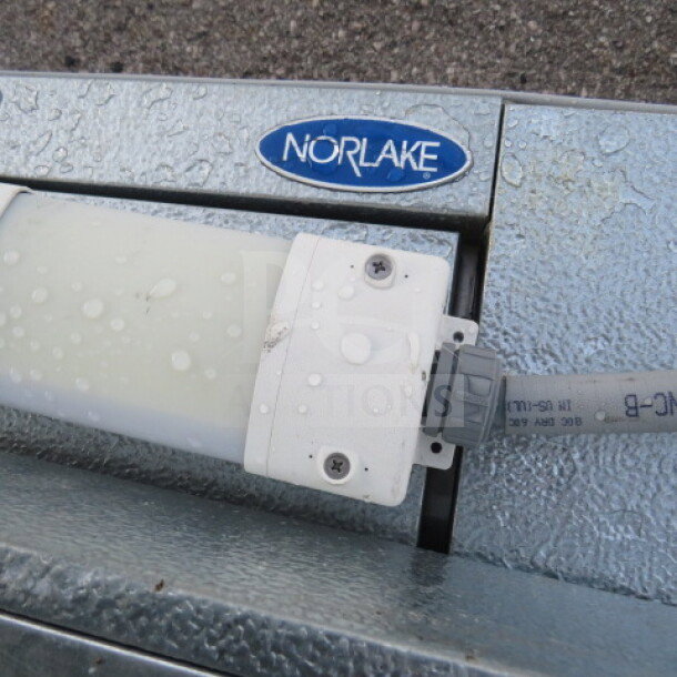 Norlake 4x6 self-contained walk-in cooler with floor, gray metallic finish, priced at $10,281, functional when removed.