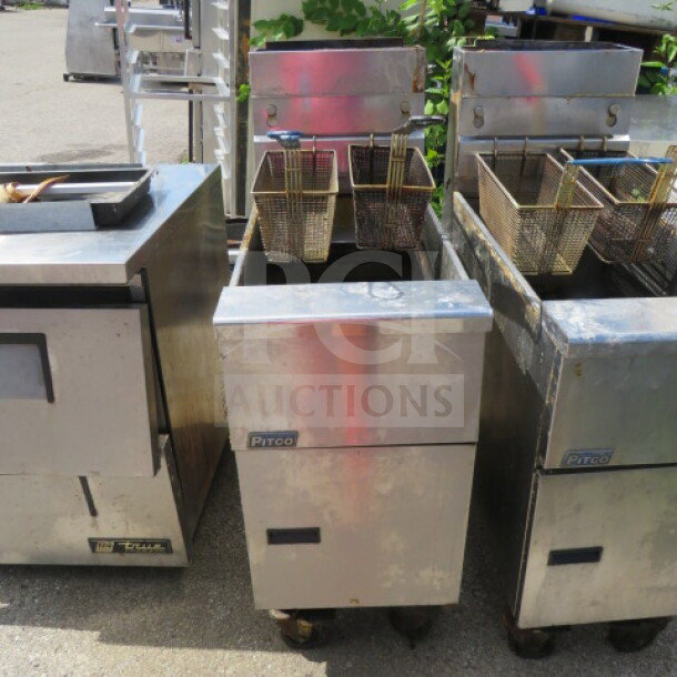 Pitco SG14 natural gas deep fryer with 2 baskets, on casters. Measures 15.5x34x45.5 inches. Visible wear on the exterior.